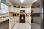 Full size appliances, custom cabinetry, and granite counters